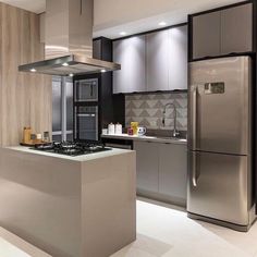 a modern kitchen with stainless steel appliances and cabinets