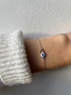 Brush away negative energy and jealous prying eyes with this dainty evil eye bracelet!  D E T A I L S  *It features a stainless steel and enamel evil eye charm. This measures around 20mm. The enamel eye actually has grooves and moves in between the oval link. *It has been wire wrapped to a dainty stainless steel chain. Choose between gold or silver. *Stainless steel does not tarnish or oxidise and is also amazingly hypo allergenic. *It closes with a stainless steel lobster clasp. *Bracelet comes with an explanatory card and is gift ready. S I Z I N G *  H E L P *Choose the length from the drop down menu. Use the length guide as a reference. If unsure what size you need you can choose to ask for an extender to be added in the personalisation section. C A R E * T I P Stainless steel is very Metal Evil Eye Bracelet With Adjustable Chain As Gift, Adjustable Silver Chain Bracelet With Evil Eye, Sterling Silver Evil Eye Bracelet With Adjustable Chain, Silver Metal Evil Eye Bracelet As Gift, Adjustable Hypoallergenic Silver Evil Eye Bracelet, Silver Evil Eye Chain Bracelet Gift, Dainty Evil Eye Bracelet With Adjustable Chain, Handmade Minimalist Evil Eye Bracelet, Dainty Evil Eye Bracelet For Everyday