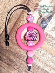 a pink pacifier with an image of the word mama on it's side