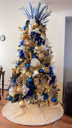 a christmas tree with blue and gold decorations