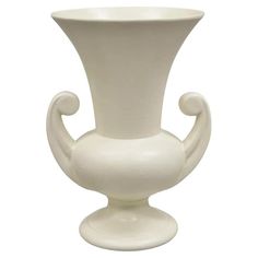 a white vase is sitting on a stand