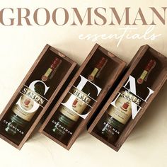 three bottles of groomsman's essentials in wooden boxes