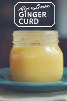 a glass jar filled with liquid sitting on top of a blue plate