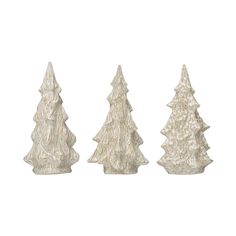 three white ceramic christmas trees on a white background