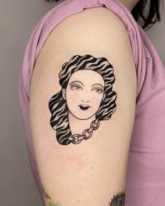 a woman's arm with a black and white portrait tattoo on it