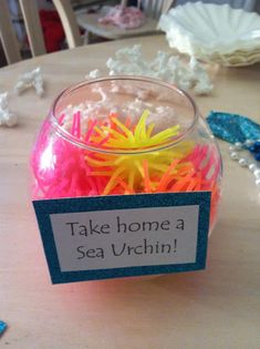 a jar filled with sea urchins sitting on top of a table