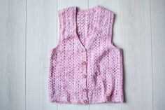 Pretty 90s vintage vest, handmade sweater vest with very cute pink buttons. Ideal vintage condition.  Vintage condition on a scale 1-10 is 10 The itchiness of wool on a scale of 0-5 for this item is 1 Size: seems like women's (M) & men's (S) Measurements: Length: 59 cm/ 23" Shoulder to shoulder: 36 cm/ 14" Chest: 89 cm/ 35" Fabric: wool, acrylic Brand: Handmade More vintage vests here: https://www.etsy.com/dk-en/shop/TumbleweedsATTiTUDE?section_id=26366388 Whole shop here: https://www.etsy.com/s Vintage Vests, Vest Handmade, Vintage Sweater Vest, Pull Rose, Sleeveless Jumper, Handmade Sweater, Vintage Vest, Sweater Vest Women, Rose Vintage