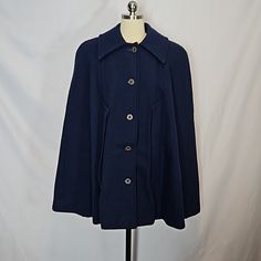 Vintage Pendleton Wool Navy Blue Cape, Estimate Size Is A Small Or Med. Cape Is Lined With A Purple Satin Lining--Lining Is Showing Signs Of Wear With Some Repairs And Some Frayed Areas As Shown, The Top Button Hole Has Some Missing Threads. The Outer Wool Layer Is In Very Nice Condition With No Noted Holes/Flaws. The Cape Is Heavy Weighing About 2.75 Lbs. The Label Is Similar To One Dated From The 70's. No Size Tag, Size Listed Is An Estimate. See Measurements. Measured Flat: Length: 33" Should Classic Formal Cape For Fall, Classic Double-breasted Peacoat, Classic Blue Peacoat With Button Closure, Classic Blue Peacoat With Buttons, Blue Fall Cape Outerwear, Blue Cape Outerwear For Spring, Blue Cape For Fall, Classic Blue Outerwear For Fall, Blue Cape