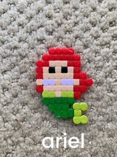 an image of a brooch that is made out of legos on the carpet