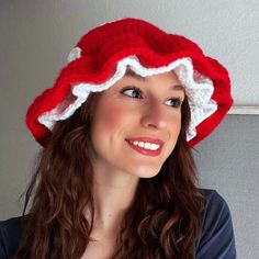 a woman wearing a red and white crocheted santa hat