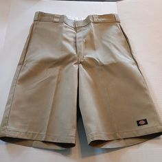 These Dickies Twill Work Shorts Are Perfect For Any Occasion, Whether It's For Travel, Casual Wear, Workwear, Or Even For Business Meetings. They Come In A Solid Beige Color And Have A Relaxed Fit With A 38-Inch Waist Size And An 13-Inch Inseam. The Shorts Feature A Hook & Eye Closure, Slash Pockets, And A Flat Front. Made From A Blend Of Polyester And Cotton, The Shorts Are Durable And Fade-Resistant, Making Them Perfect For Outdoor Activities. They Are Also Wrinkle-Resistant, Ensuring That You Dickies Outfits Men, Dickies Outfit, Dickies Khaki, Mad Cat, Estilo Cholo, Dickies Shorts, Mens Shorts Outfits, Mens Jean Shorts, Solid Beige