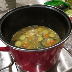 a pot filled with soup sitting on top of a stove