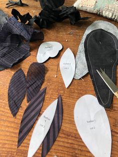 several pieces of fabric and scissors are laying on the table next to some cut up hearts