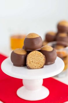 a white cake plate topped with chocolate covered cookies