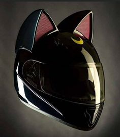 a helmet with a cat's face on it is shown in the shape of a motorcycle helmet