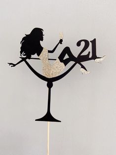 a cake topper with the number twenty two and a woman in a dress on it