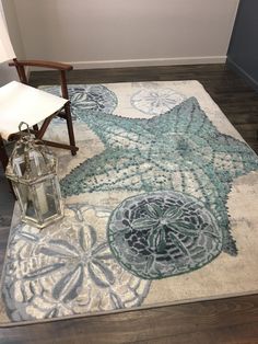 a chair sitting on top of a wooden floor next to a rug with an intricate design