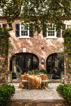 an outdoor dining area in front of a brick building