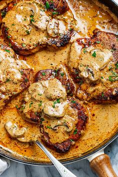 a pan filled with meat covered in sauce and mushrooms