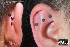 two people with piercings on their ears and behind them is the first blood logo