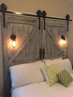 an image of a bed with headboard made out of wood and lights on it