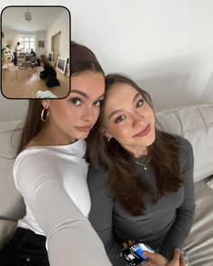 two women are taking a selfie in their living room