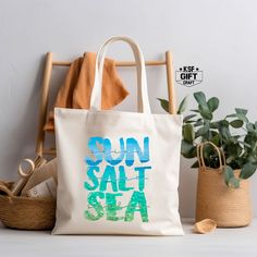 "Sunshine Saltwater Seashells Tote Bag, Summer Gifts For Women, Ocean Vibes Bag, Girls Vacay Bag, Trendy Beach Tote Bag, Gift For Summer Bag Personalized tote bags are perfect for yourself, Your Company, or as a gift! These are also the ideal bride's, Bridal Shower, Baby Shower, Birthday Party, gift, or proposal gift. PRODUCT *Measurements15\"L x 16\"H *12 oz./yd² (US), 20 oz (CA), 100% heavy cotton canvas *20\" canvas webbed handles * 9\" handle drop *Made from Heavy duty cotton canvas fabric *DTF printing for the best color quality * Bulk discounts are available upon request. *Put N/A In the personalization Box For  Blank Tote Bag  Check the Tote bag Color And Text Color Chart In display Pictures Before Order HOW TO ORDER    *Put N/A In the personalization Box For  Blank Tote Bag   *Make Summer Beach Canvas Pouch Bag, Beige Bags For Beach Season Gift, Blue Beach Bag For Summer Gift, Summer Blue Beach Bag As Gift, Blue Beach Bag For Summer, Eco-friendly Bags For Summer Gifts, Eco-friendly Bags As Summer Gifts, Summer Gift Shoulder Beach Bag, Summer Beach Shoulder Bag As Gift