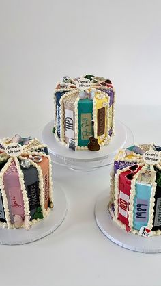 three decorated cakes sitting on top of each other in front of a white background,