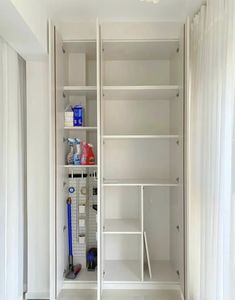 a white closet with shelves and tools in it