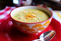 a bowl of soup on a red place mat