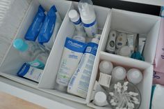 an open drawer containing several bottles and other personal care items, including toothbrushes