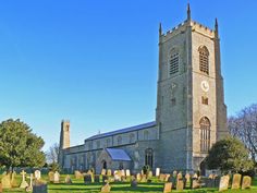 an old church with graveyards in the foreground