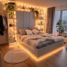 a bedroom with lights on the walls and a large bed in it's center