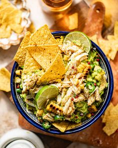 a bowl filled with chicken salad and tortilla chips