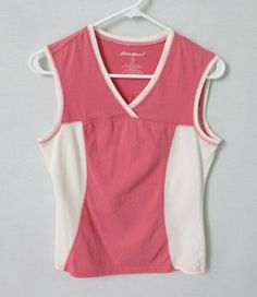 Eddie Bauer pink white sleeveless athletic activewear top *Sz XS*    Excellent condition, no flaws V-neckline Decorative seaming front and back Sleeveless Pullover styling Straight hemline Measurement from shoulder seam to shoulder seam is 14" Chest measurement from side seam to side seam is 17" Length from back of neck to lowest point of hem is 22-1/2" 70% cotton, 30% polyester Machine wash and dry Kept in a smoke free, pet free environment   Make sure you check out Mrs. G's Special Tees sectio Sleeveless Cotton Sports Top, White Cotton Sporty Tank Top, Pink V-neck Activewear For Workout, Sleeveless Cotton Sportswear Tops, Athletic Fit Sleeveless Cotton Top, White Sleeveless Cotton Activewear, Sleeveless Sportswear Tops For Light Sports, Pink Athleisure Tops, Sleeveless Sportswear Top For Spring