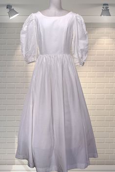 "Elegant white fit and flare wedding dress - Laura Ashley, Made in GB label. Fitted bodice, huge puff sleeves, one pocket, long sweeping skirt, wrap over back.  Demure, simple and beautiful. Fabric is a cotton/viscose mix and medium weight.   In good cared for condition.  There is a slub on the skirt which has been overstitched to prevent it from becoming loose.  See photo. It's a size 12 on the label but measures like a modern day UK 8 Chest:  up to 34\" Waist:  26\" Hips:  Free Shoulder to hem:  54\" Please ask if you have any questions  :)  Please note:  this is a used item, not new and not pristine.  My items have been in storage and may require laundering.  If there is a problem with your order please contact me straight away - I always work with my customers to try and resolve any is White Fitted A-line Ball Gown, White A-line Gown For Debutante Ball, White A-line Wedding Ball Gown, White A-line Ball Gown For Wedding, Elegant Vintage Puff Sleeve Wedding Dress, A-line Wedding Dress With Fitted Bodice For Formal Event, A-line Wedding Dress With Fitted Bodice For Debutante Ball, Classic A-line Vintage Wedding Dress, White A-line Ball Gown With Fitted Bodice