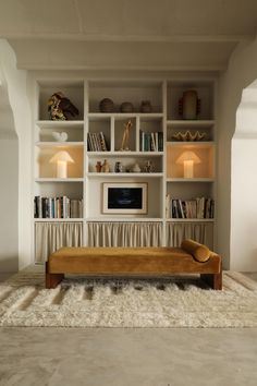 a living room filled with lots of furniture and bookshelves on top of each other