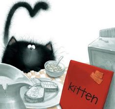 a black cat sitting on top of a table next to a red sign that says kitten