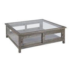 a glass and wood coffee table with two drawers on each side, against a white background