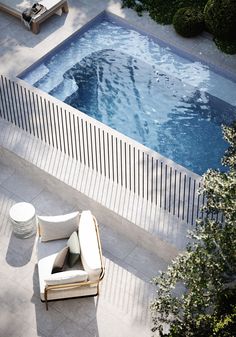 an aerial view of a swimming pool and lounge chair