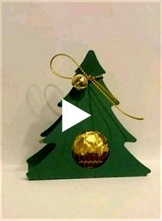 an ornament shaped like a christmas tree with gold ornaments on it's top