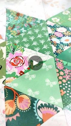 an image of a patchwork quilt with flowers and leaves on the fabric, as if it were made from scrapbook paper