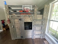 a loft bed with a basketball hoop on it