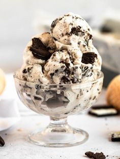 an ice cream sundae with cookies and oreo chips on top in a glass bowl