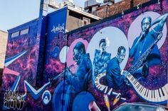 a mural on the side of a building with musical instruments painted on it's sides