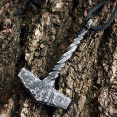 This unique item is handmade and made to order by the artist MagicRebel This is a forged iron handmade Viking style pendant. The pendant is a mini replica of an ancient Nordic hunting hammer tool. Style is unisex, looks good on both men and women.Hammer length is about 1.95-2.15" inches or 50-55mm. Pendant comes on a black leather necklace and is coated by a water resistant finish to protect from rusting.PLEASE NOTE: This is a handmade item and each one looks slightly different. Some details suc Viking Thor, Thor's Hammer Necklace, Mjolnir Pendant, Unisex Looks, Hammer Tool, Hammered Necklace, Iron Jewelry, Thor Hammer, Black Leather Necklace