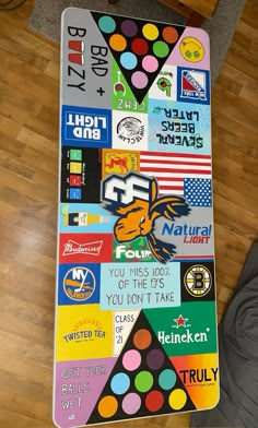 a table covered in stickers and magnets on top of a hard wood floor