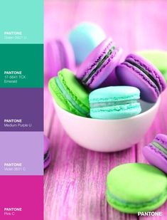 there are many different colored macaroons in the bowl