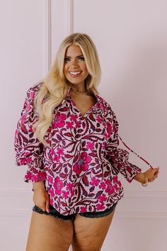 - Let your bubbly personality shine through with this beautiful top! - Unlined material with pink, blue, and purple hues and tangerine highlights - An abstract floral print as well as a subtle striped pattern - A ruffled v-cut neckline with a tie detail - Pleated shoulder details - Long, loose sleeves with smocked ruffle cuffs - Pleated detail - A relaxed silhouette that ends in a straight hemline