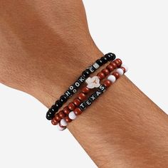 A whole new way to rep the team in style is here. Step up your fan fashion sense with this Texas Longhorns 3 Pack Beaded Friendship Bracelet. These matching friendship bracelets have an all-over team-colored design and team logo displays, which makes them the perfect way to show your support for the Texas Longhorns on gamedays and every day in between. Every bead bracelet design is the perfect addition to your outfit, whether you’re heading to the game, watching at home, or just hanging out with Casual Personalized Beaded Bracelets For Fans, Casual Beaded Bracelets In Team Colors For Sports Events, Casual Friendship Bracelets With Letter Beads, Casual Round Beads Bracelets For Sports Events, Casual Personalized Friendship Bracelets, Black Adjustable Beaded Bracelets For Team Spirit, Personalized Casual Friendship Bracelets, Casual White Wristband For Game Day, Black Adjustable Beaded Bracelets Team Spirit Style